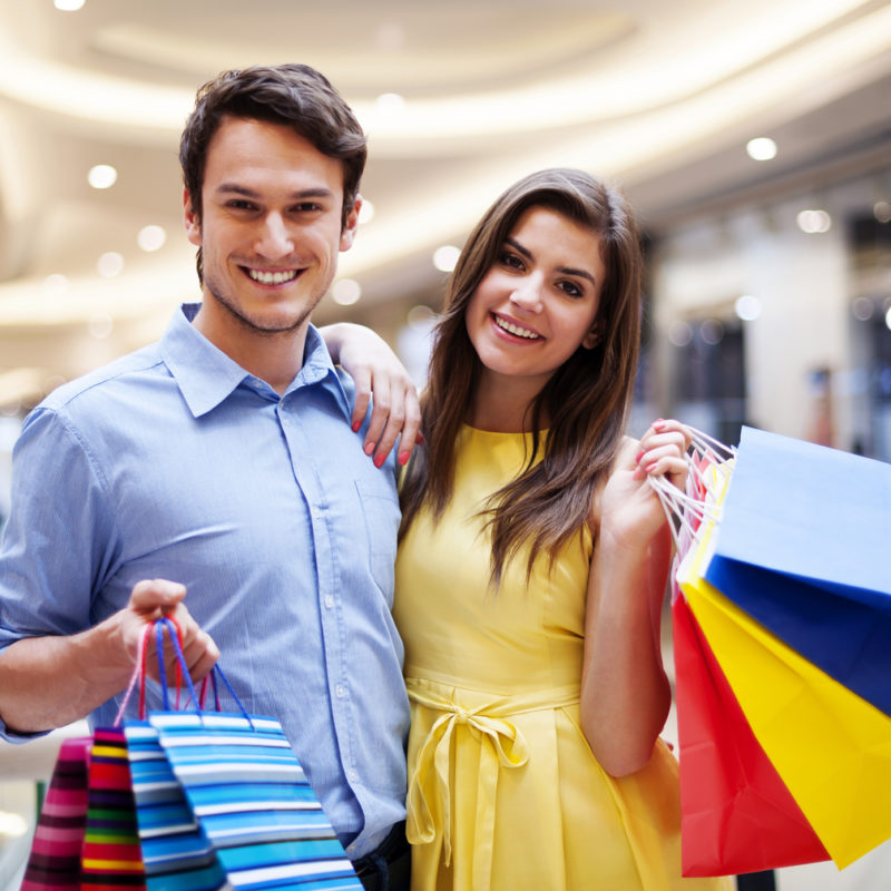 Portrait of happy couple with shopping bags